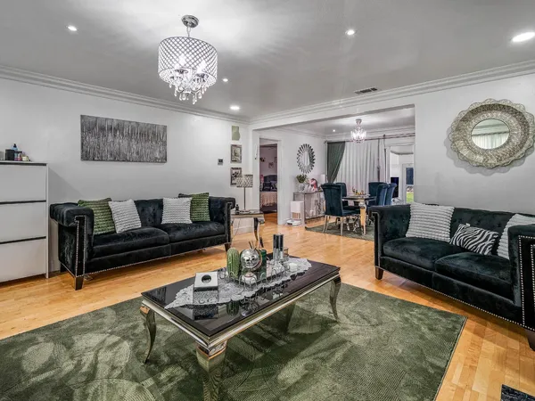 a living room with furniture and a chandelier