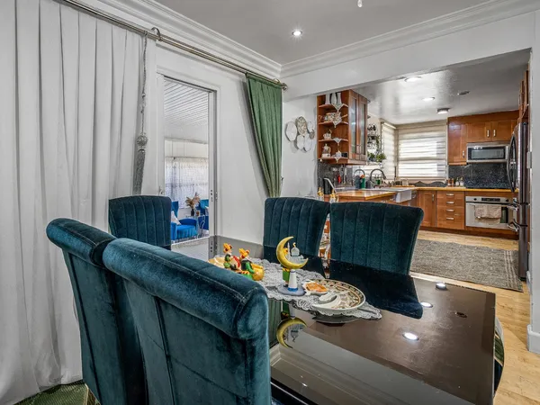 a dining room with furniture and wooden floor