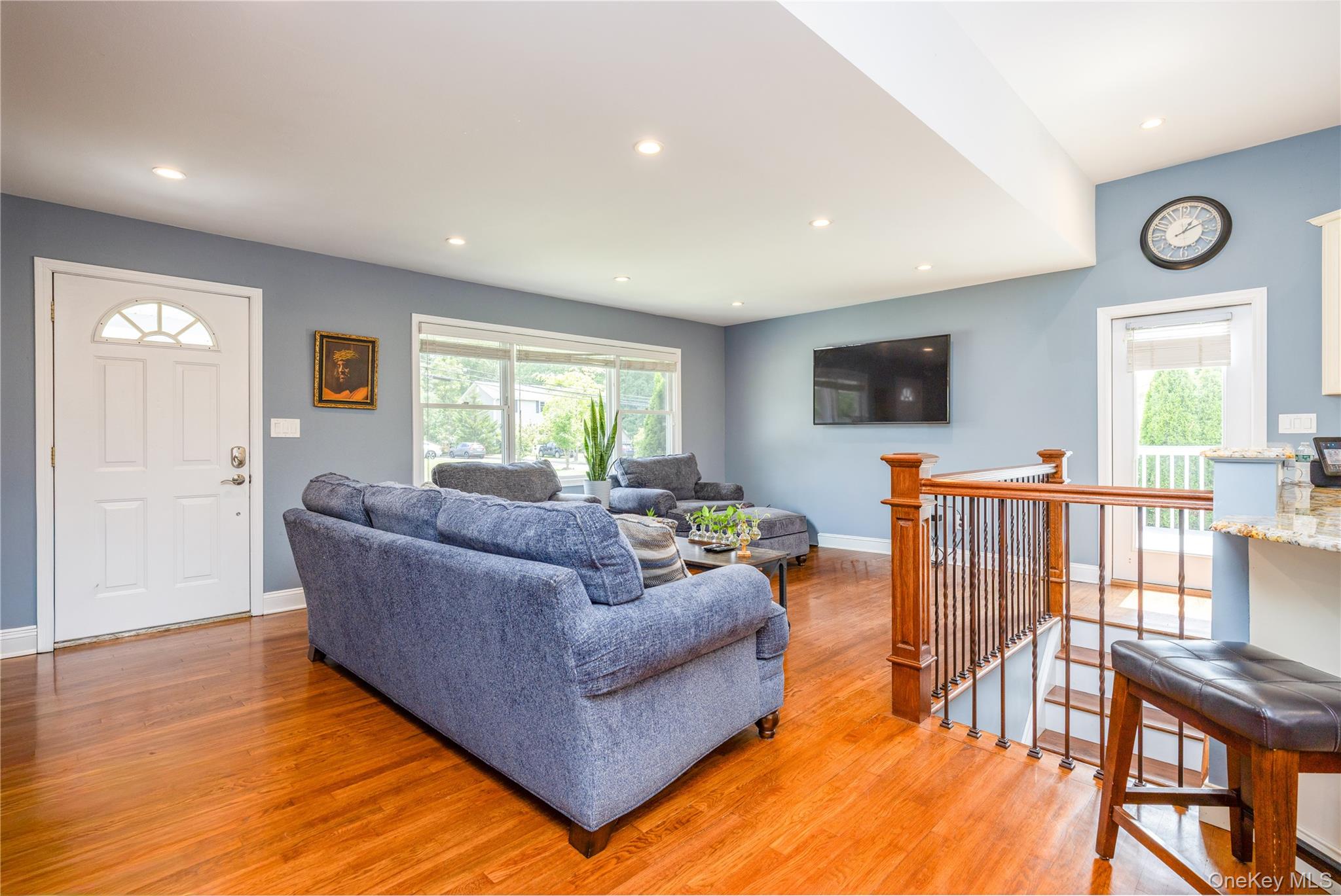 395 Ehrhardt Road Pearl River, NY 10965 - Photo 5 of 34 Bright, open living area showcasing gleaming wood-finish flooring throughout, recessed ceiling lighting, and soft blue-gray wall finishes