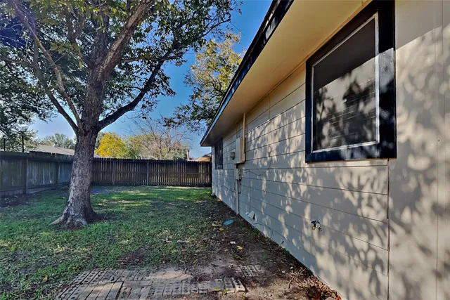 a view of a backyard with a tree