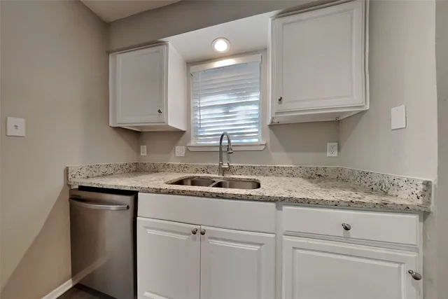 a kitchen with appliances cabinets and a counter top space