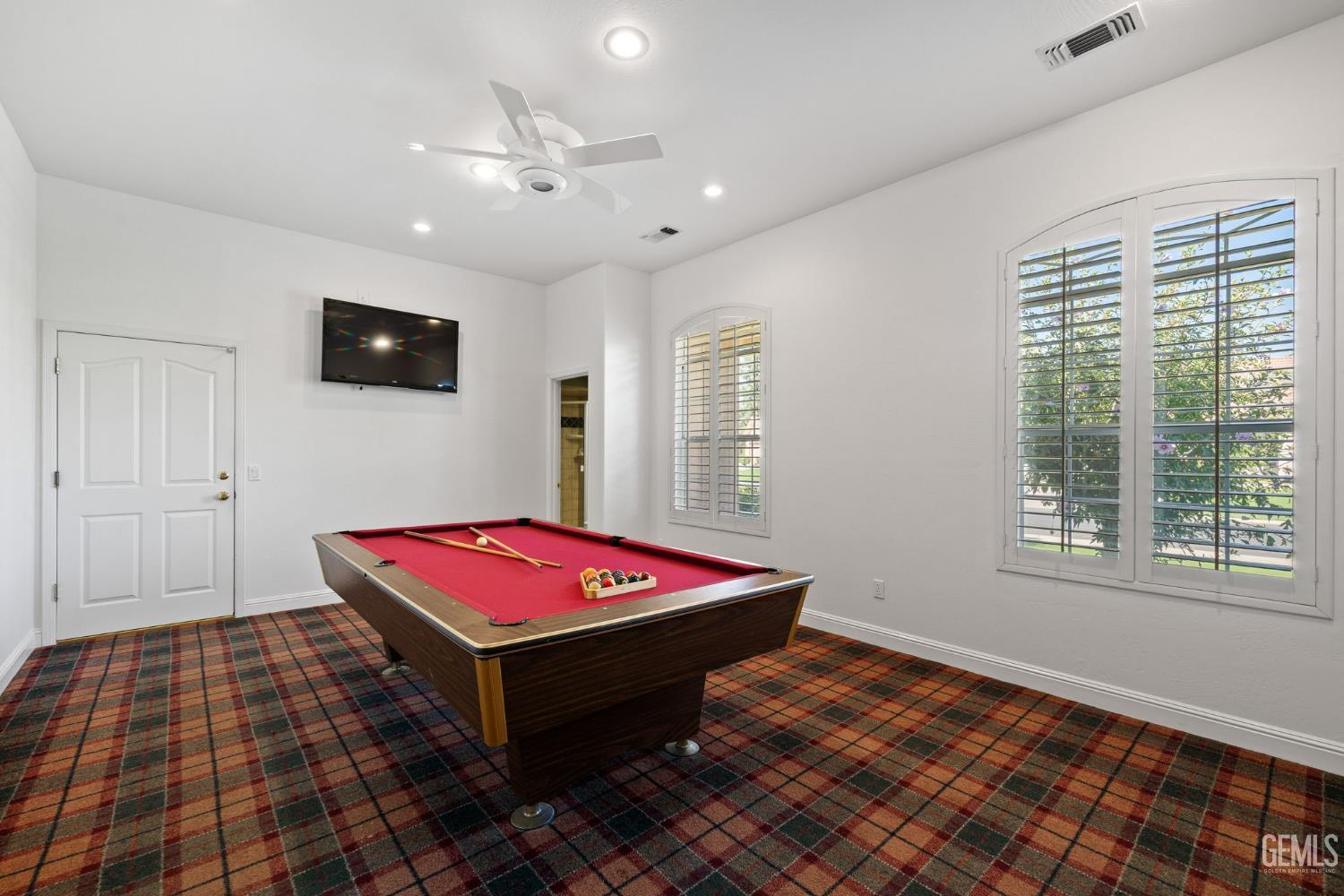 Undisclosed Address Bakersfield, CA 93308 - Photo 15 of 30 a room with pool table and a flat screen tv