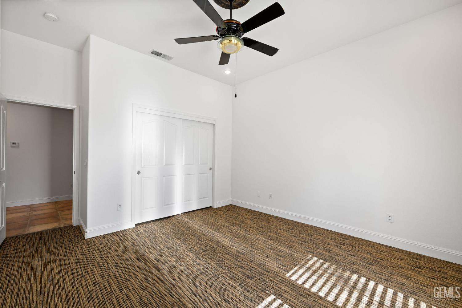 Undisclosed Address Bakersfield, CA 93308 - Photo 18 of 30 a view of an empty room with wooden floor