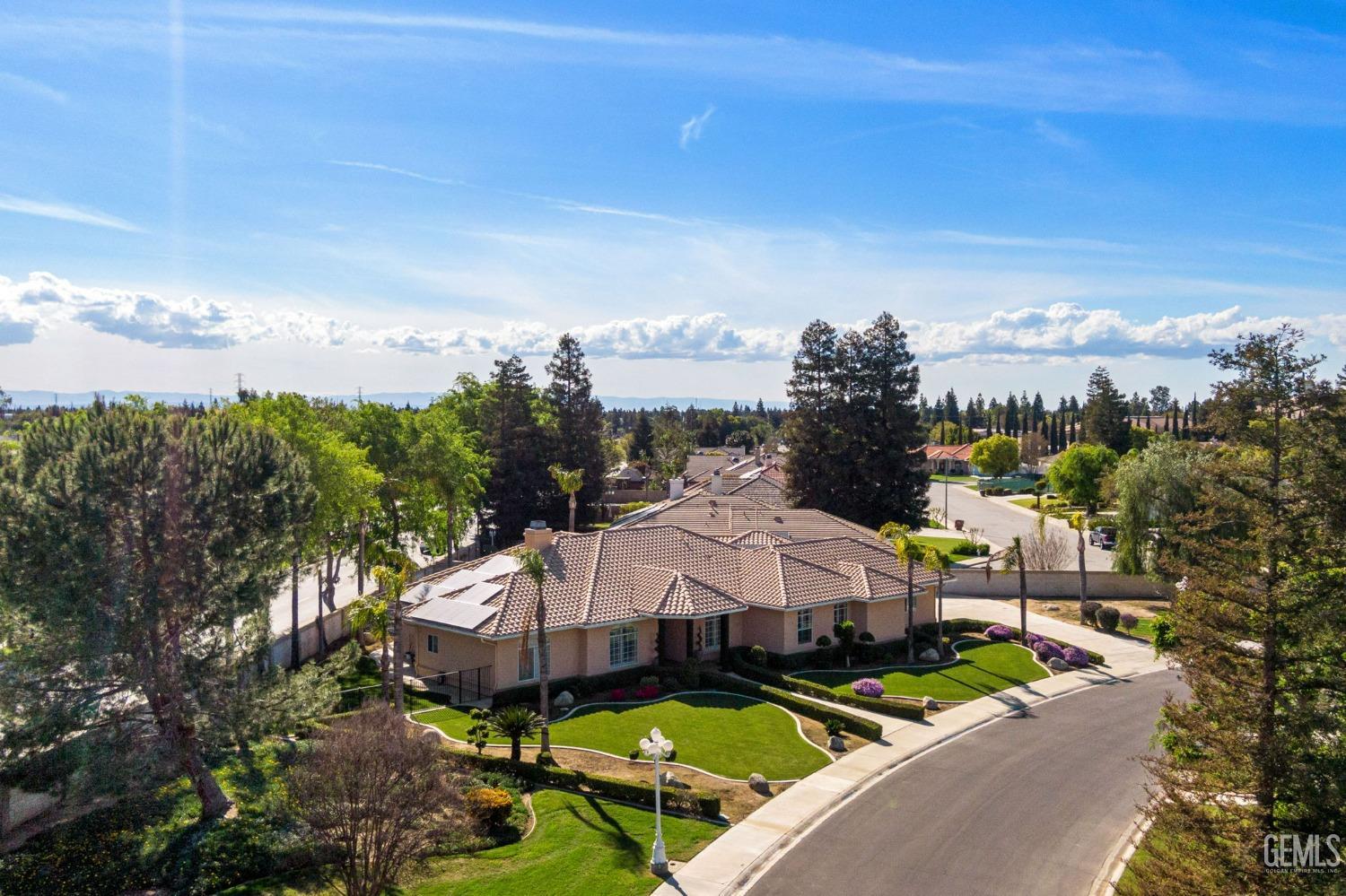 Undisclosed Address Bakersfield, CA 93308 - Photo 3 of 30 a view of a big yard with potted plants and large tree