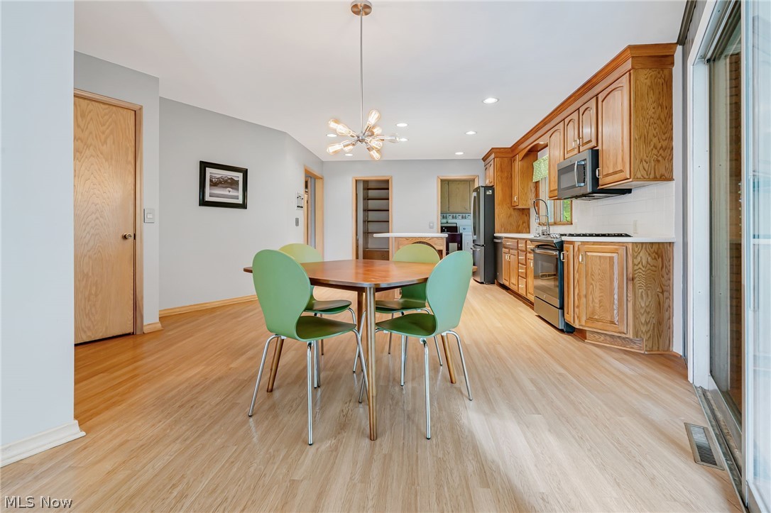 1010 Knollwood Road Northwest Canton, OH 44708 - Photo 14 of 47 Dining space with light hardwood / wood-style floors and a notable chandelier