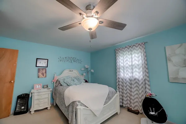 a bedroom with a bed and a chandelier