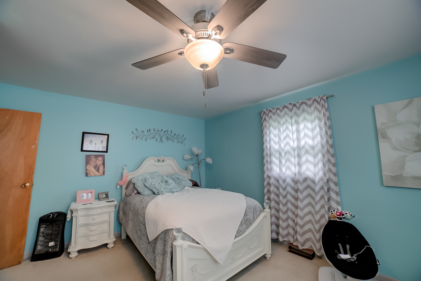 205 North Park Street Milford, IL 60953 - Photo 12 of 23 a bedroom with a bed and a chandelier