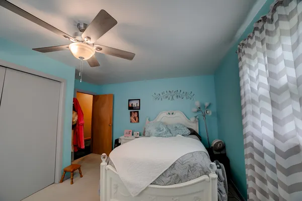 a bedroom with a bed and a chandelier