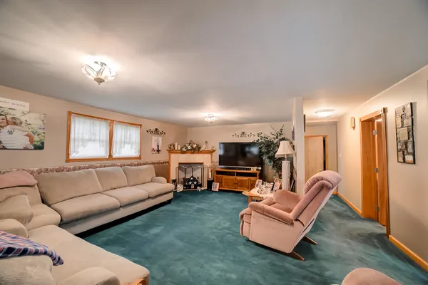 a living room with furniture fireplace and a window