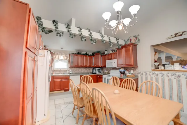 a view of a dining room with furniture and a chandelier