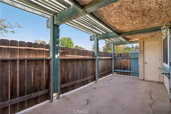 a view of backyard with small cabin and wooden fencing