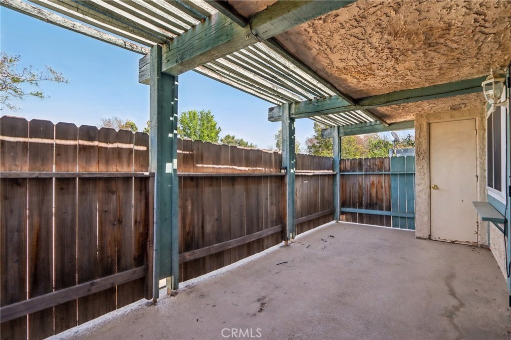 2561 Gonzaga Lane Riverside, CA 92507 - Photo 11 of 48 a view of backyard with small cabin and wooden fencing