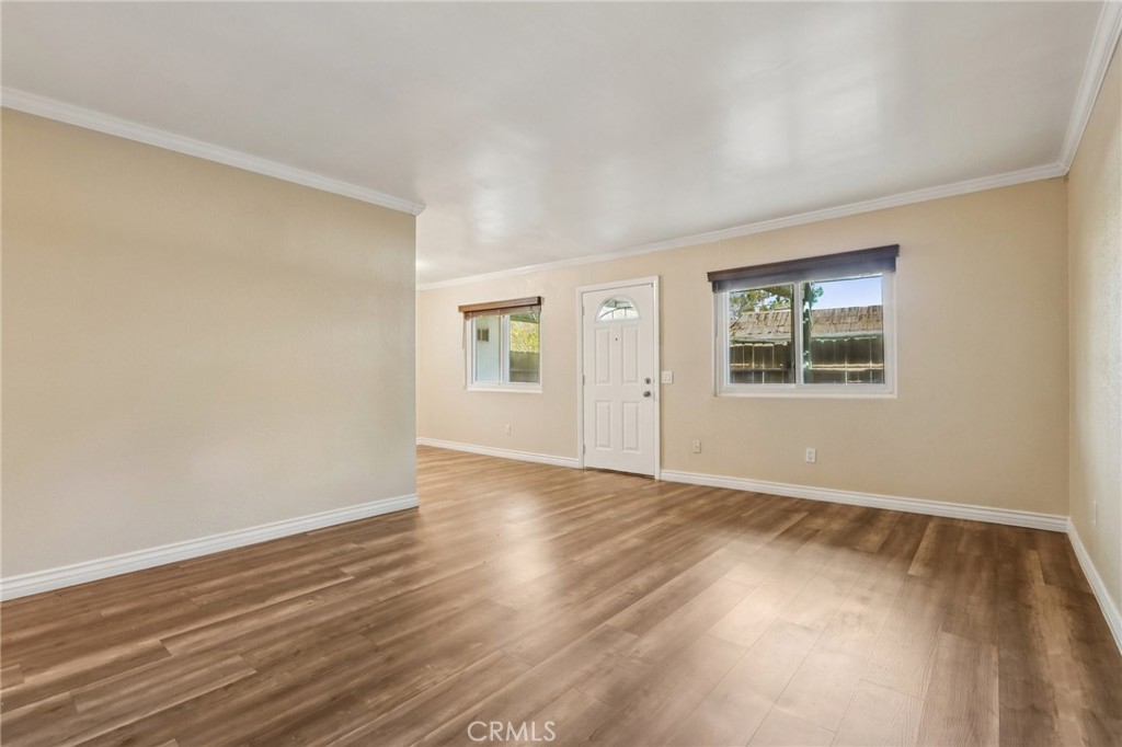 2561 Gonzaga Lane Riverside, CA 92507 - Photo 14 of 48 a view of an empty room with wooden floor and a window