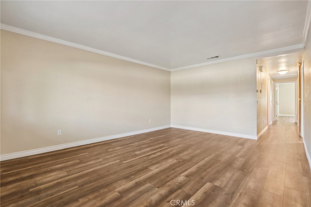 2561 Gonzaga Lane Riverside, CA 92507 - Photo 15 of 48 a view of an empty room with wooden floor and a window