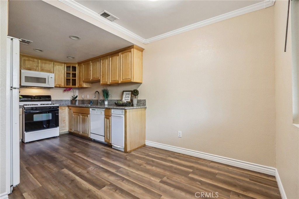 2561 Gonzaga Lane Riverside, CA 92507 - Photo 17 of 48 a kitchen with granite countertop white cabinets and white appliances