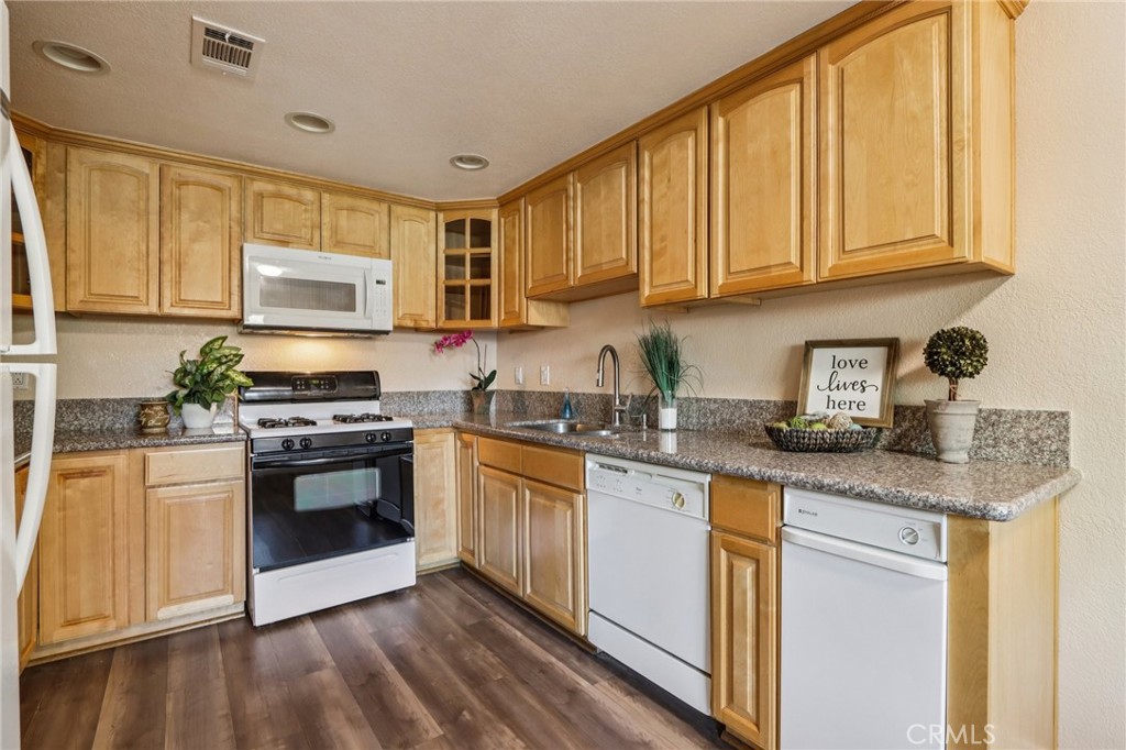 2561 Gonzaga Lane Riverside, CA 92507 - Photo 2 of 48 a kitchen with stainless steel appliances granite countertop a stove a sink and a microwave