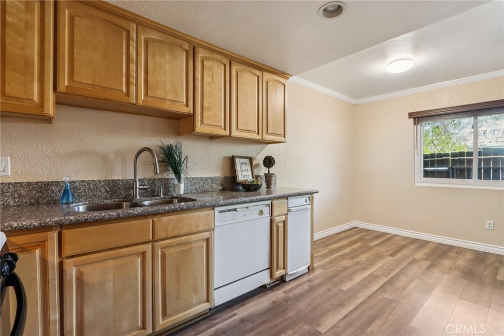 2561 Gonzaga Lane Riverside, CA 92507 - Photo 21 of 48 a kitchen with granite countertop wooden cabinets a sink and dishwasher