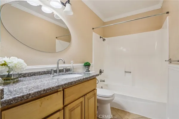 a bedroom with a large bed and a potted plant