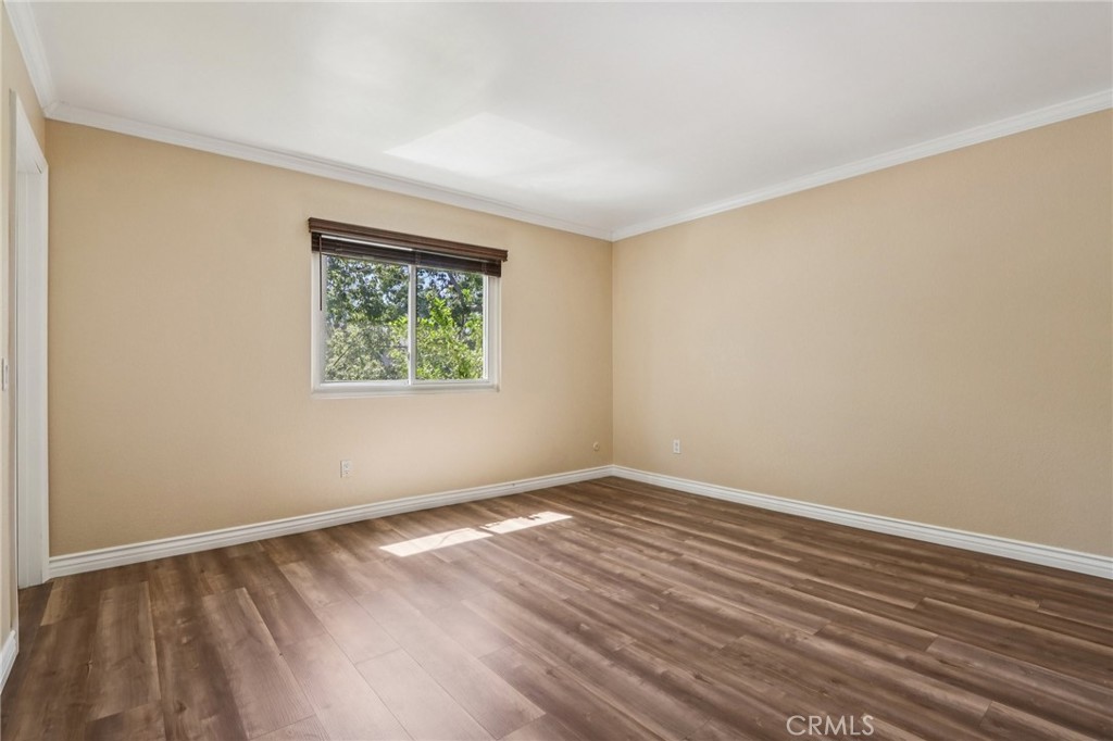 2561 Gonzaga Lane Riverside, CA 92507 - Photo 29 of 48 a view of an empty room with wooden floor and a window