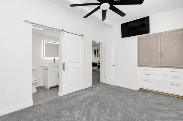 a view of a livingroom with an empty space and a ceiling fan