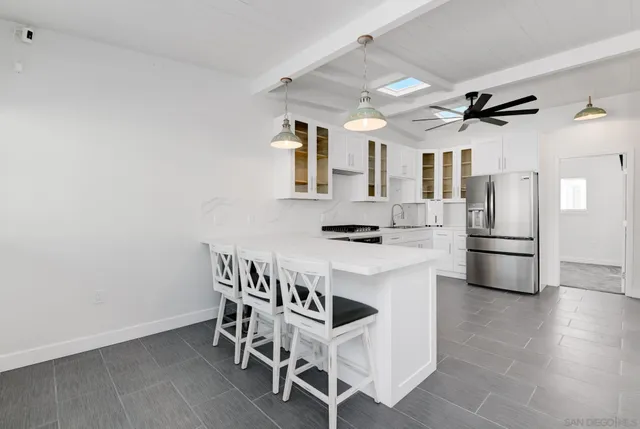 a kitchen with stainless steel appliances a white stove top oven and a refrigerator