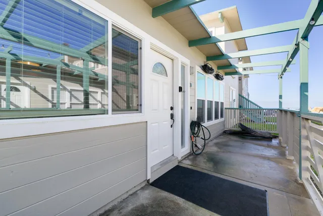 a view of a porch with a table and chairs