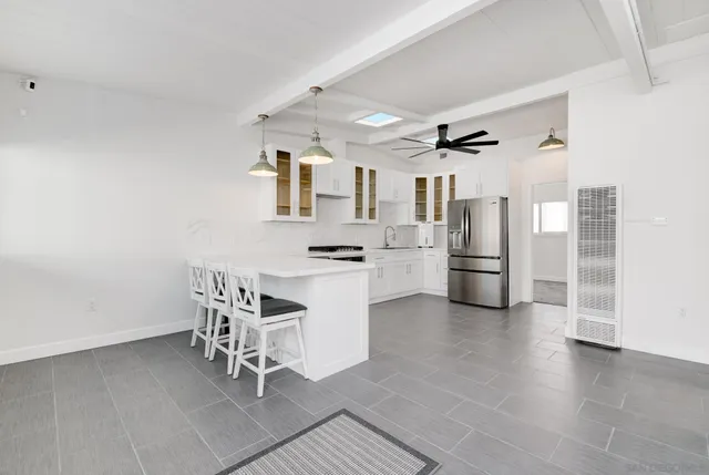 a kitchen with cabinets and chairs