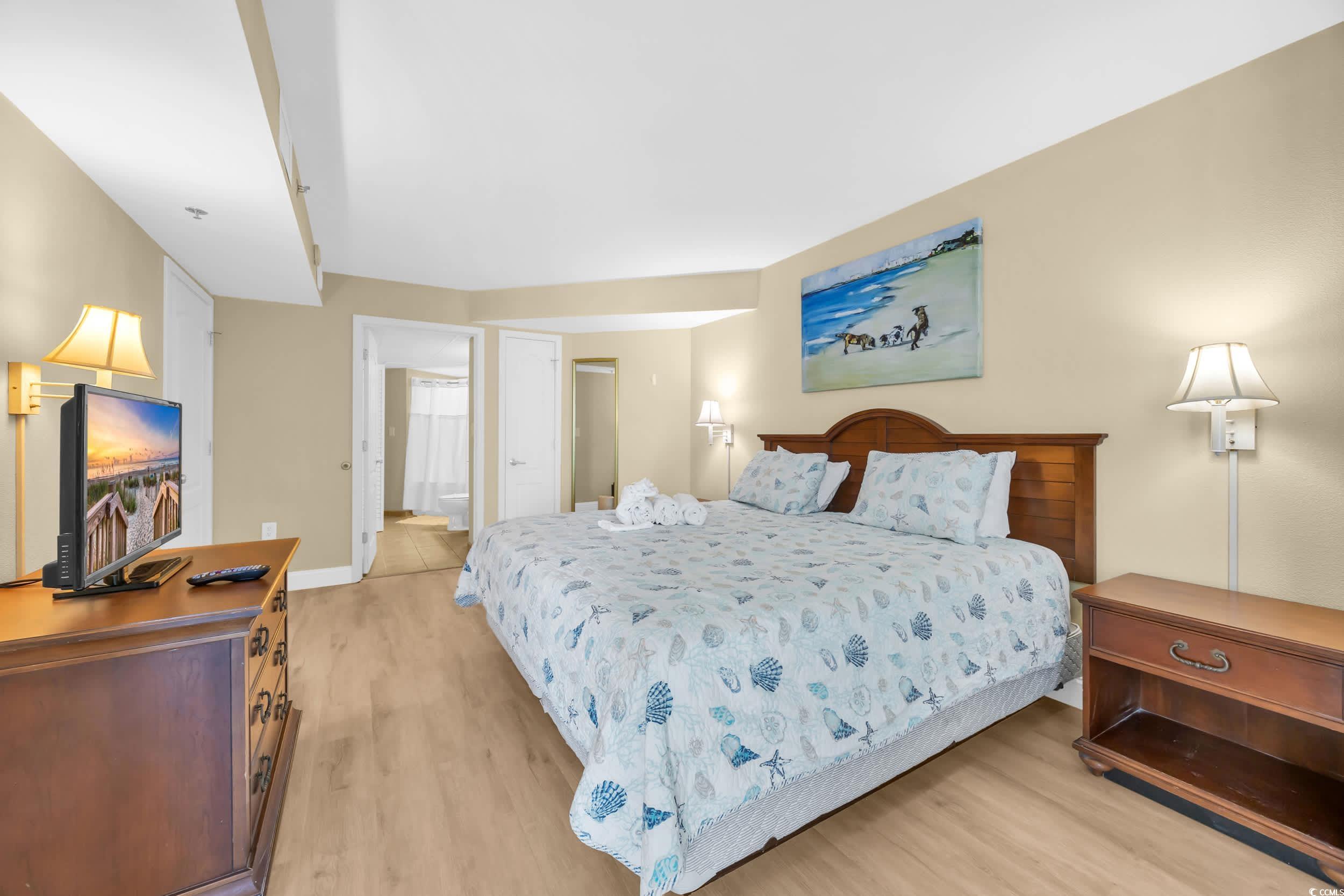 2504 North Ocean Boulevard, Unit 1234 Myrtle Beach, SC 29577 - Photo 11 of 22 Bedroom with light wood-style floors and a closet