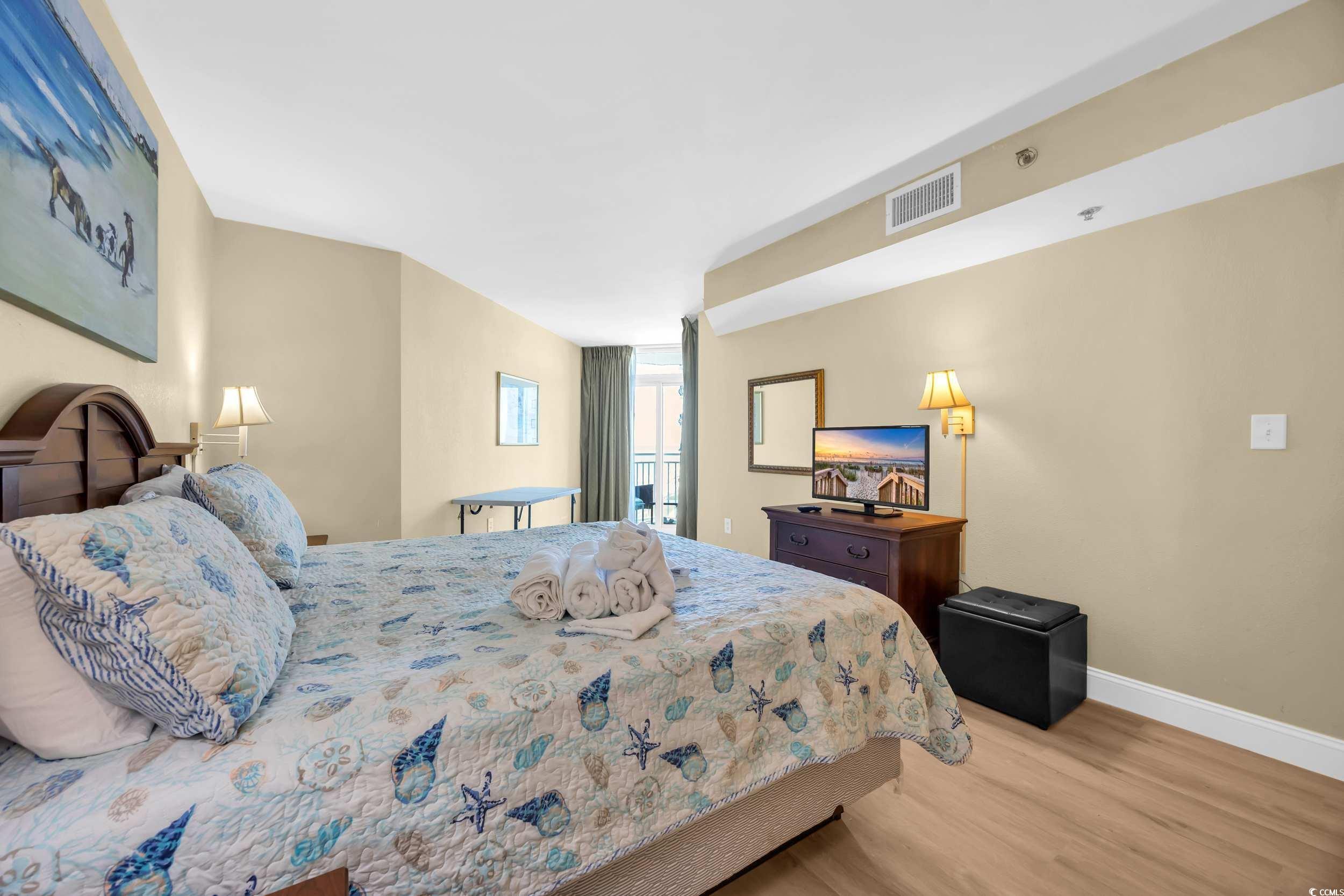 2504 North Ocean Boulevard, Unit 1234 Myrtle Beach, SC 29577 - Photo 12 of 22 Bedroom featuring light wood finished floors and baseboards