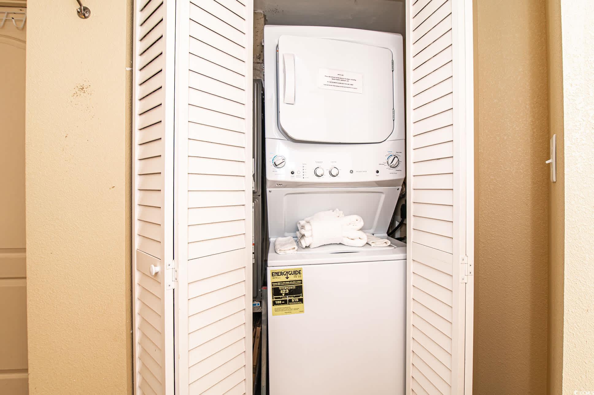2504 North Ocean Boulevard, Unit 1234 Myrtle Beach, SC 29577 - Photo 14 of 22 Laundry area with estacked washer and dryer and a textured wall