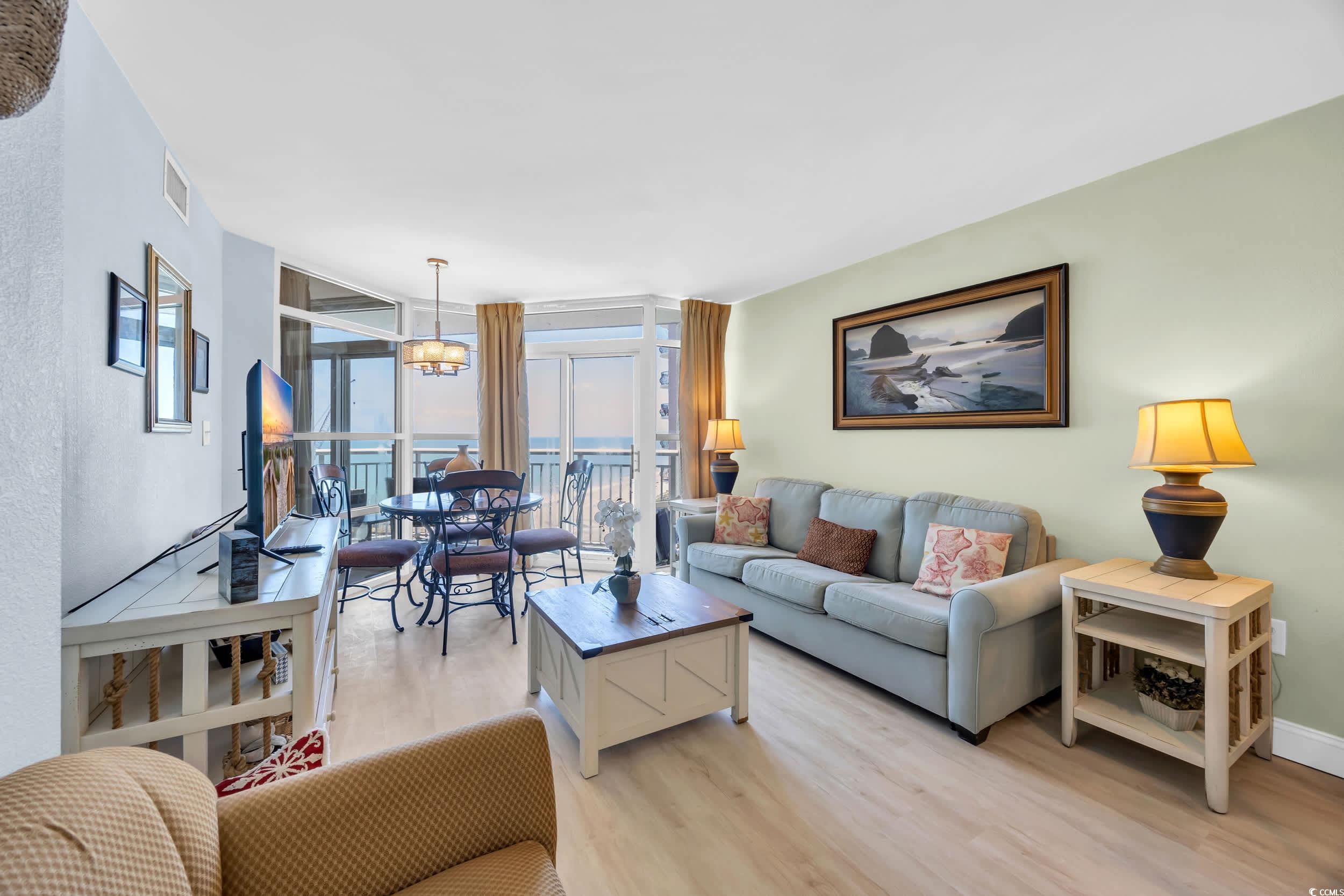 2504 North Ocean Boulevard, Unit 1234 Myrtle Beach, SC 29577 - Photo 6 of 22 Living area featuring expansive windows and light wood-style floors