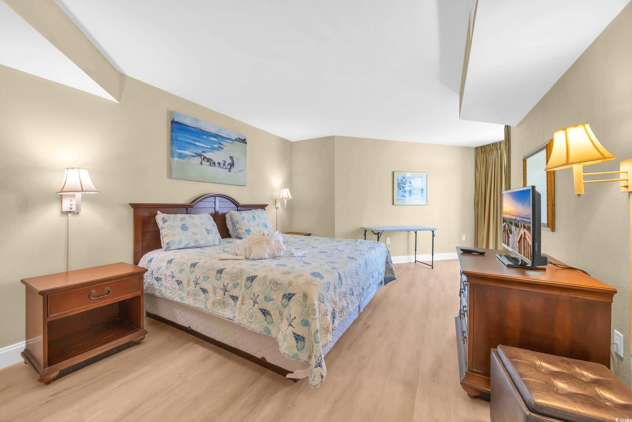 2504 North Ocean Boulevard, Unit 1234 Myrtle Beach, SC 29577 - Photo 10 of 22 Bedroom with light wood-style floors and baseboards