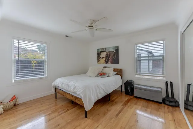 a bedroom with a bed and wooden floor