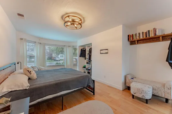 a bedroom with a bed and a window