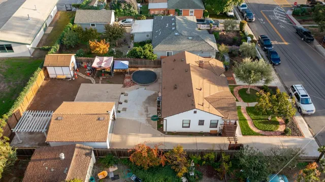 an aerial view of a house with a yard and lake view