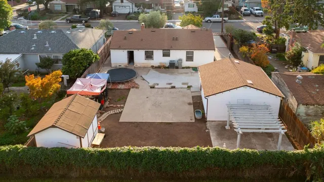 an aerial view of a house with garden space and street view