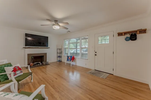 a living room with furniture a fireplace and a flat screen tv