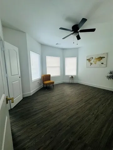 a bathroom with a granite countertop sink mirror vanity and toilet