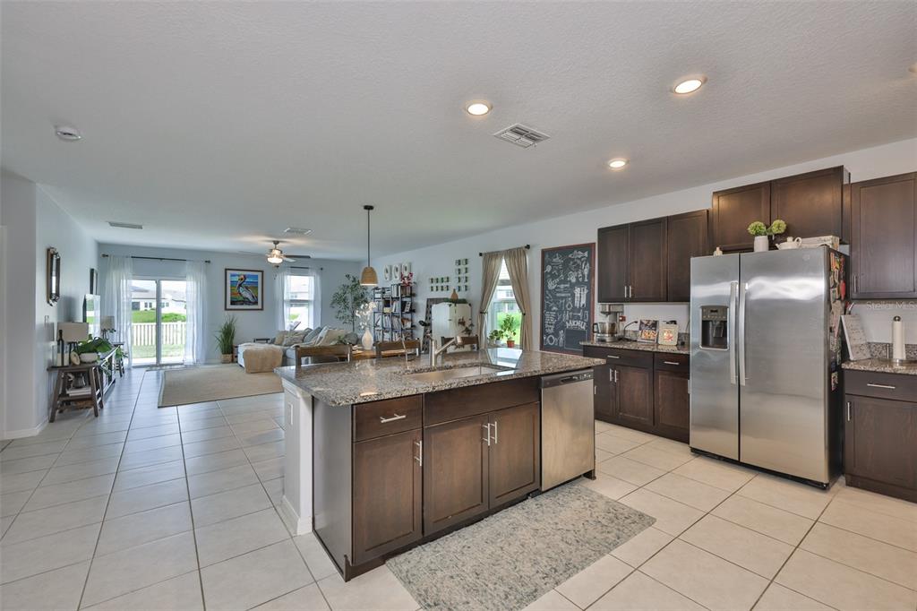 12746 Weston Oaks Lane Riverview, FL 33579 - Photo 14 of 56 a kitchen with stainless steel appliances granite countertop a sink counter space cabinets and a view of kitchen