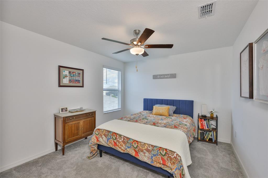 12746 Weston Oaks Lane Riverview, FL 33579 - Photo 30 of 56 a bedroom with a bed and a ceiling fan
