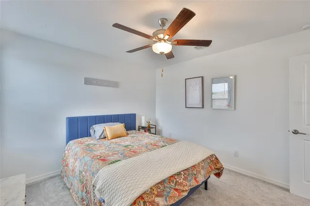 a bedroom with a large bed and a chandelier