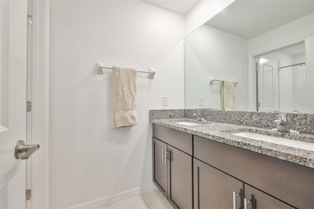 12746 Weston Oaks Lane Riverview, FL 33579 - Photo 36 of 56 a bathroom with a granite countertop sink and a mirror