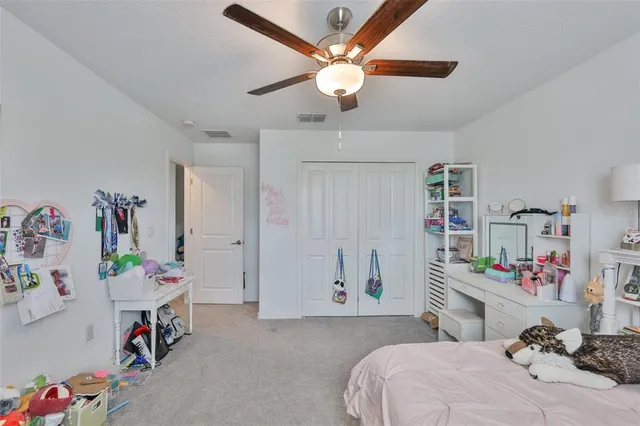 a bedroom with a bed and a table in it