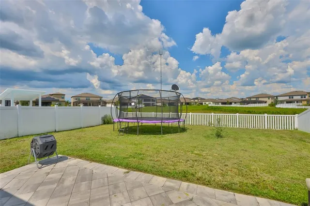 a view of an house with backyard and patio