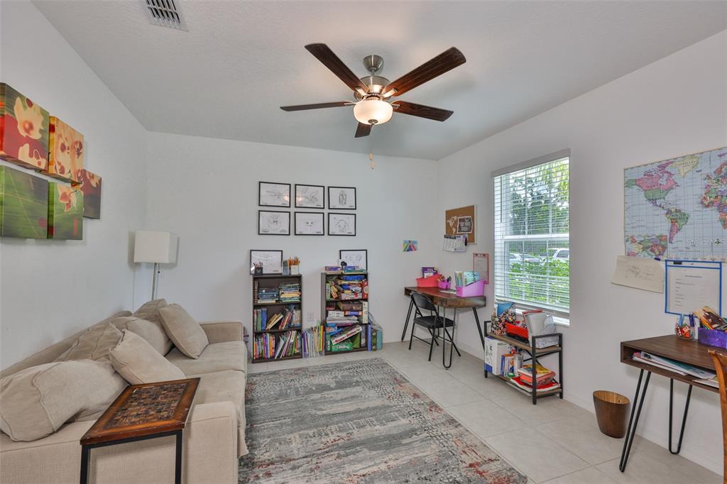12746 Weston Oaks Lane Riverview, FL 33579 - Photo 5 of 56 a living room with furniture and a flat screen tv