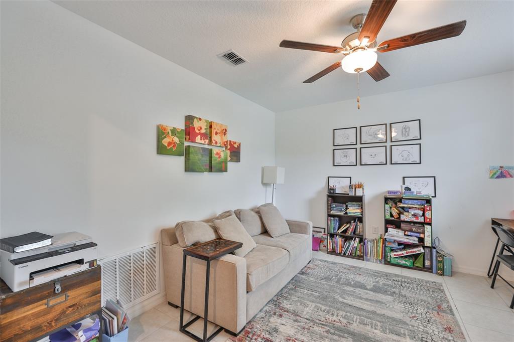 12746 Weston Oaks Lane Riverview, FL 33579 - Photo 6 of 56 a living room with furniture and a flat screen tv