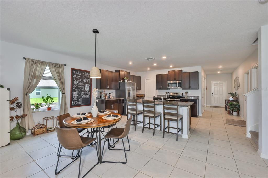 12746 Weston Oaks Lane Riverview, FL 33579 - Photo 8 of 56 a dining room filled with furniture and a large window
