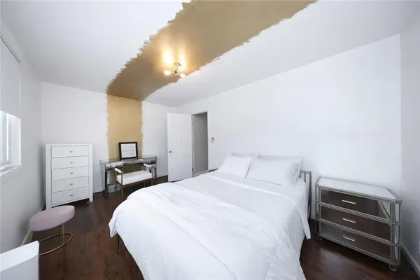 a bedroom with a bed and dresser
