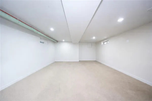 an empty room with a empty space and windows