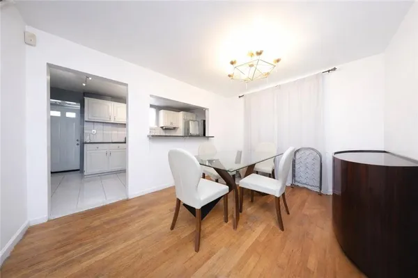 a view of a dining room with furniture and wooden floor